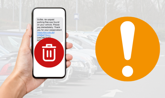 A mobile phone with scam text message being held with a red delete button over it against a background of a car park.  To the right is an orange circle with an exclamation mark to represent a warning. 