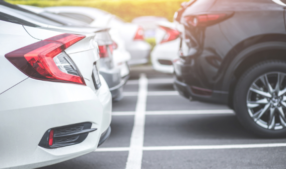 a line of cars parked in car parking spaces