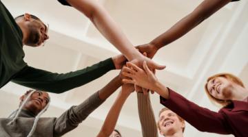 group of people with hands overlapped