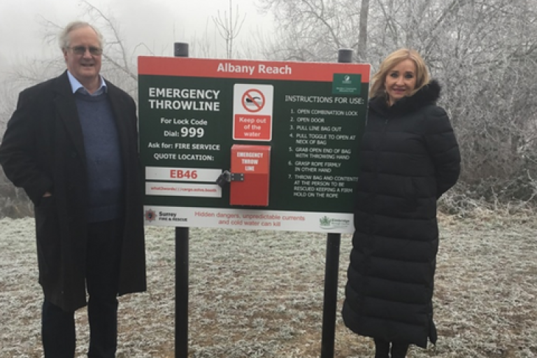 Two people standing beside the newly installed throwlines at Albany Reach.