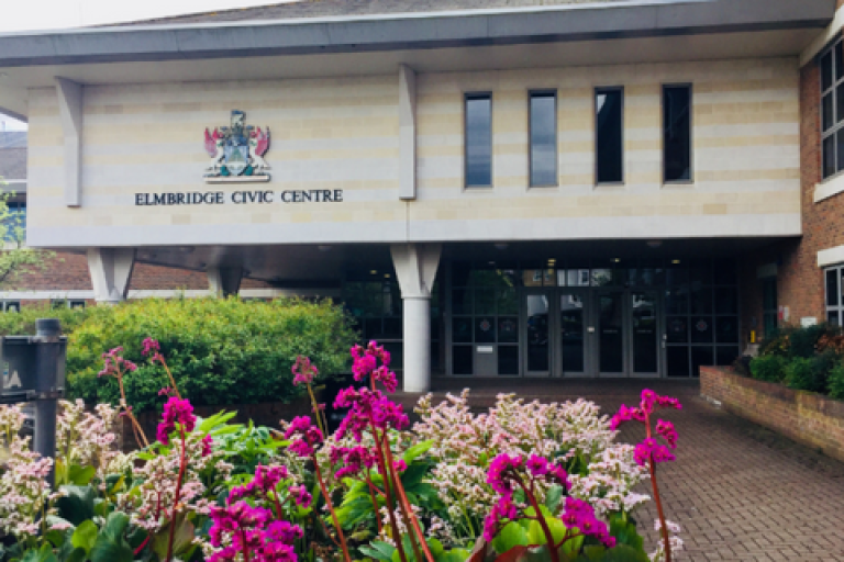 Exterior of the Elmbridge civic centre with pink flowers