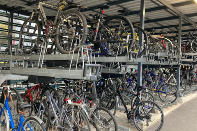 A collection of bicycles on a rack.