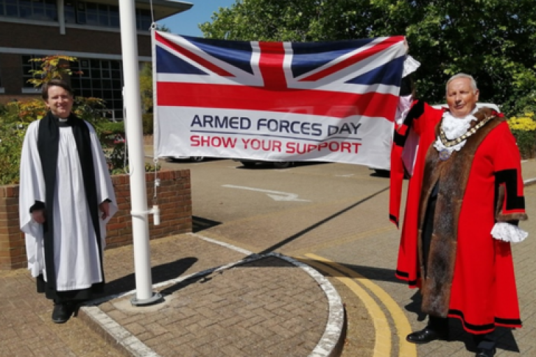 The Mayor of Elmbridge and the Mayor's Chaplain marking the start of Armed Forces week by raising the flag.