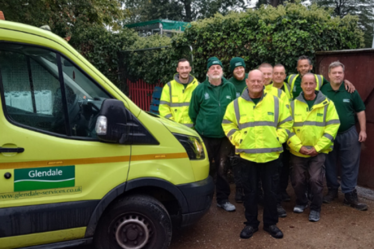 The team at Glendale standing next to a branded van.