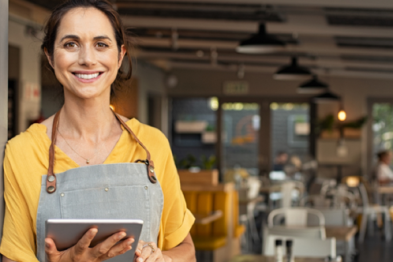 Waitress standing in front of a restaurant