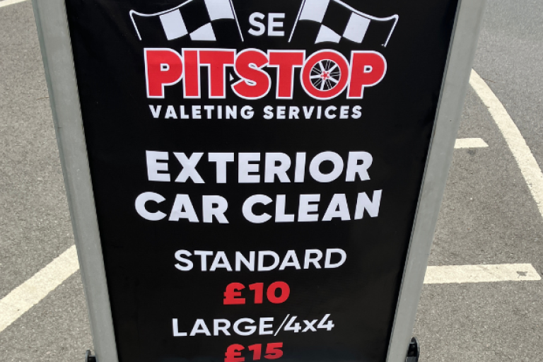 A sign for Pitstop Valeting Services promoting an exterior car clean