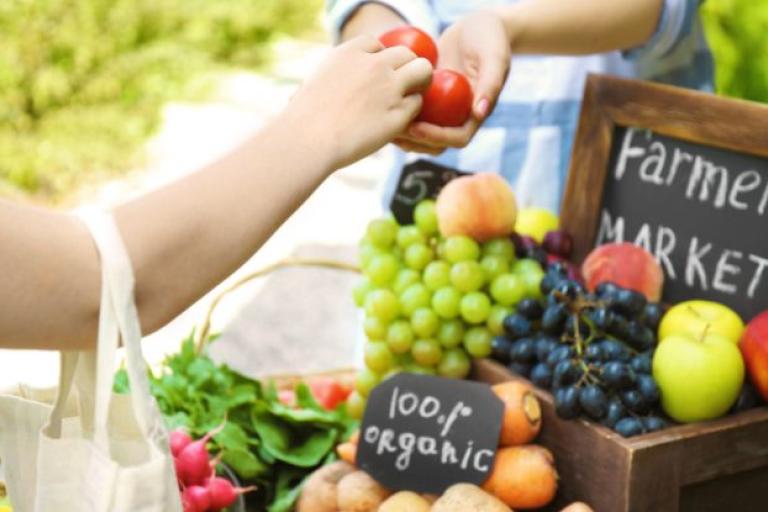 Someone buying fruit and vegetables from a market