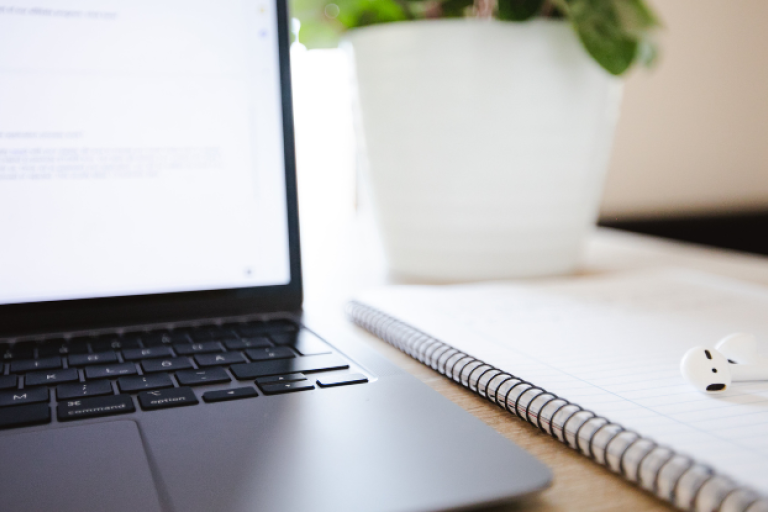 Laptop and notebook on a desk