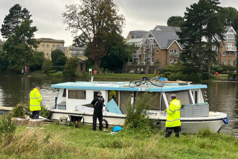 Officers inspecting a boat on the river