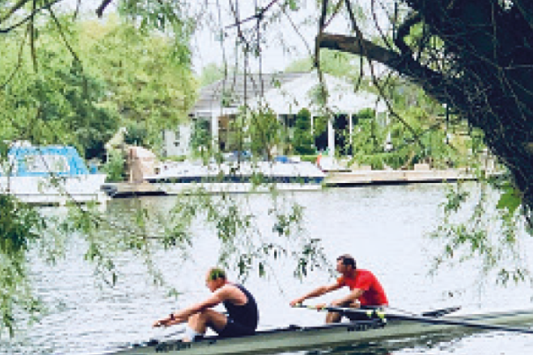 Two men rowing on the River Thames in Elmbridge