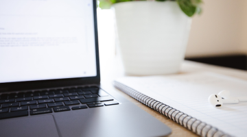 Laptop and notebook on a desk