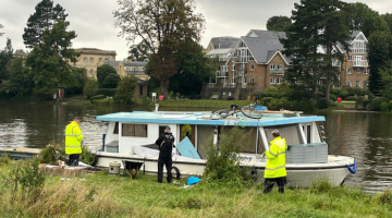 Officers inspecting a boat on the river