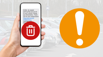 A mobile phone with scam text message being held with a red delete button over it against a background of a car park.  To the right is an orange circle with an exclamation mark to represent a warning. 