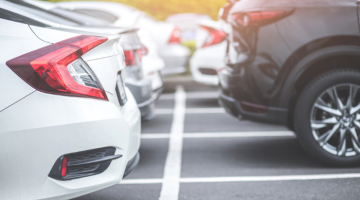 a line of cars parked in car parking spaces