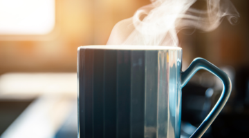 Blue mug filled with a steaming hot drink